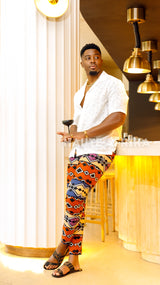 African print designed Bukavu Pants colored red, creme, blue, and black abstract African print design
